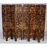 A Chinese lacquer eight-fold screen, Qing Dynasty, with incised decoration of birds and flowers to