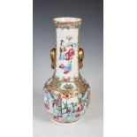 A Chinese porcelain famille rose Canton bottle vase, Qing Dynasty, decorated with panels of