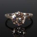 An early 20th century Art Deco white metal diamond solitaire ring, set with a round brilliant cut