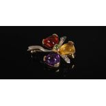 A yellow and white metal multi-gem set flower brooch, circa 1970, centred with a round faceted
