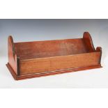 A 19th century mahogany book trough, the shaped ends with reeded detail, 70cm wide x 24cm high.