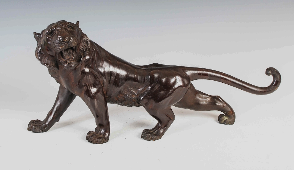 A Japanese bronze tiger, Meiji Period, signed, 55cm wide x 28.5cm high.