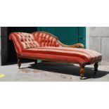 A Victorian mahogany chaise longue, with button down back and arm, the stuff over seat raised on