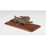 An early 20th century cold painted bronze model of a galloping hare, mounted on rectangular oak