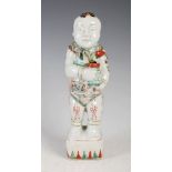 A Chinese porcelain famille verte figure of a boy, Qing Dynasty, modelled standing holding a vase