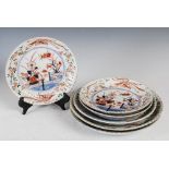 Six assorted Japanese Imari dishes, Edo Period, decorated with fenced garden of flowers and foliage,