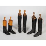 Three pairs of vintage black leather riding boots, each with original wooden boot trees, one set
