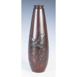 A Japanese bronze vase, late Meiji/ Taisho Period, decorated in relief with manchurian crane over