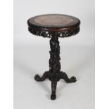 A Chinese dark wood occasional table, Qing Dynasty, the circular top with mottled red and white