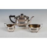 A George VI three piece silver tea set, London, 1939, makers mark of C&Co., oval shaped with