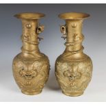 A Pair of Chinese bronze bottle vases, Qing Dynasty, decorated in relief with dragons contesting