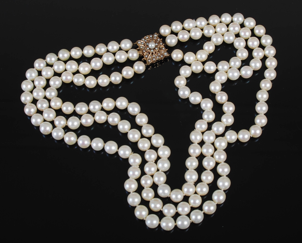 A cultured pearl necklet with 9ct gold and pearl set clasp, triple matinee length rows of forty-