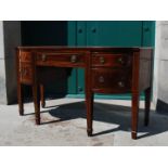 A 19th Century mahogany and boxwood lined bow front sideboard, with central frieze drawer flanked by