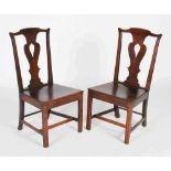 A pair of George III oak Provincial side chairs, with pierced vase shaped splats above solid planked