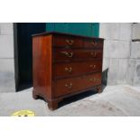A George III mahogany chest, the rectangular top with moulded edge over two short and three long