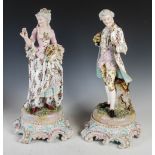 A pair of late 19th century Dresden porcelain figures, the male modelled standing holding a rose
