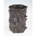 A Chinese bronze brush pot, Qing Dynasty, modelled in the form of a tree stump with ruyi fungus,