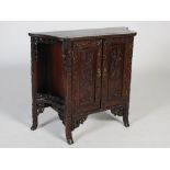 A Chinese dark wood side cabinet, Qing Dynasty, the shaped panel top with a beaded edge above two