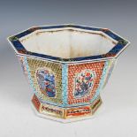 A Chinese porcelain octagonal shaped jardiniere, Qing Dynasty, the exterior decorated with panels of