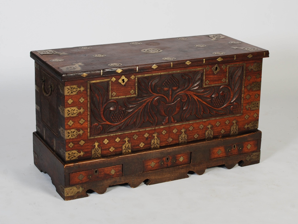 A 19th century Anglo-Indian brass bound chest on stand, the hinged rectangular top inlaid with