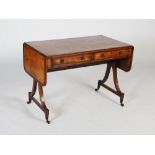 An early 19th century mahogany and rosewood sofa table, the rectangular top with twin drop leaves