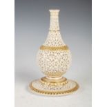A Grainger & Co. Royal Worcester reticulated bottle vase, dated 1902, on integral circular stand,