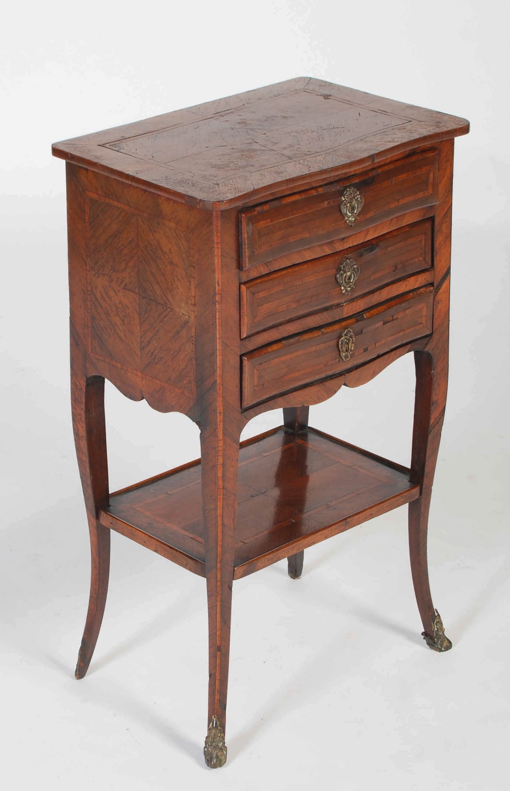 A late 19th century French kingwood occasional table, the shaped rectangular top above three shallow