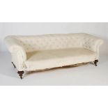 A 19th century Chesterfield sofa, the white upholstered button down back and arms above a