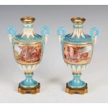 A pair of 19th century French porcelain ormolu mounted twin handled urns, decorated with hand