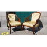 A near pair of Edwardian rosewood and marquetry inlaid tub armchairs