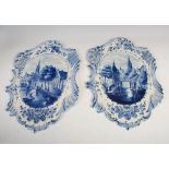 A pair of late 19th century Delft style blue and white pottery wall plaques, decorated with oval