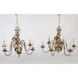 A pair of early 20th century brass six light chandeliers, with double-headed eagle finials on ball