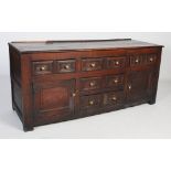 A late 18th/ early 19th century oak dresser, the planked rectangular top with moulded edge above a