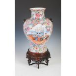 A Chinese porcelain famille rose millefleurs vase, Republic Period, decorated with two lozenge