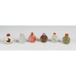 A collection of six Chinese cut and polished stone snuff bottles and stoppers, Qing Dynasty and