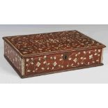A 19th century Anglo-Indian ivory and ebony inlaid writing box, the hinged cover decorated with