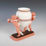 A Mintons table centrepiece, modelled in the form of two putti carrying a Grecian urn, impressed