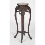 Chinese dark wood jardiniere stand, Qing Dynasty, the octagonal shaped top centred with a mottled