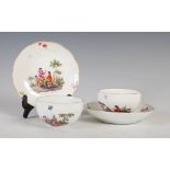 A pair of Meissen porcelain tea cups and saucers, painted with vignettes of figures and scattered