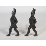 A pair of early 20th century cast iron andirons in the form of marching soldiers, 51.5cm high x 53cm