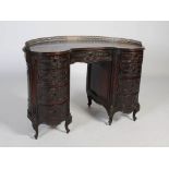 A late 19th century French mahogany kidney-shaped knee-hole desk, the shaped top with pierced