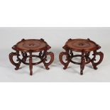 A pair of Chinese dark wood jardiniere/ floor vase stands, early 20th century, the circular stands