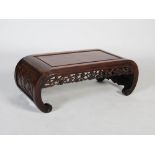 A Chinese dark wood Kang table, late Qing Dynasty, the rectangular panelled top above a pierced