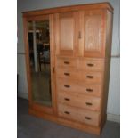 A Victorian pine wardrobe, the plain cornice over a rectangular bevelled mirror door flanked by a