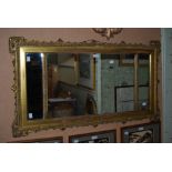 A 19TH CENTURY GILT WOOD OVER MANTLE MIRROR OF RECTANGULAR FORM