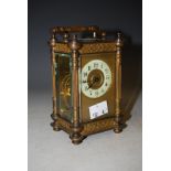 AN EARLY 20TH CENTURY BRASS CASED CARRIAGE CLOCK WITH CIRCULAR ARABIC NUMERAL DIAL AND FRET WORK