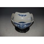 A CHINESE BLUE AND WHITE PORCELAIN SQUARE FORM BOWL DECORATED WITH FAN SHAPED PANELS OF FIGURES ON