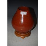 A CHINESE ORANGE GROUND PORCELAIN VASE WITH SPECKLED GROUND ON HARDWOOD STAND, INCISED MARKS