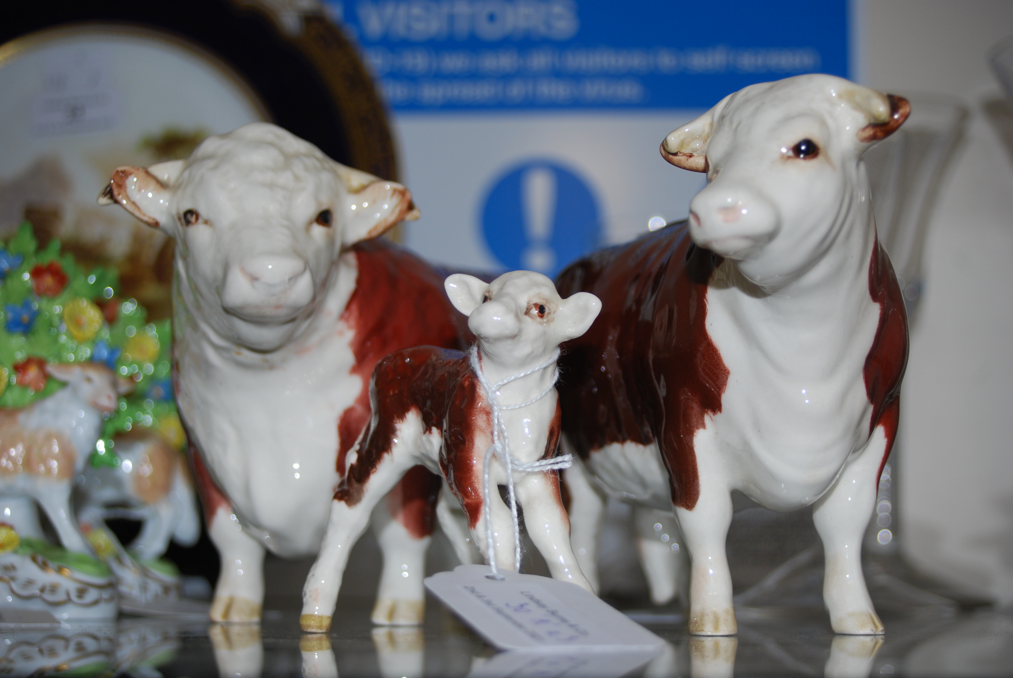 A GROUP OF THREE BESWICK 'CHAMPION OF CHAMPIONS' CATTLE TO INCLUDE BULL, COW AND CALF WITH BROWN