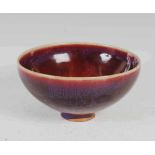 A CHINESE PORCELAIN SANG-DE-BOEUF FOOTED BOWL, QING DYNASTY, OF TAPERED CYLINDRICAL FORM, 8.5CM HIGH